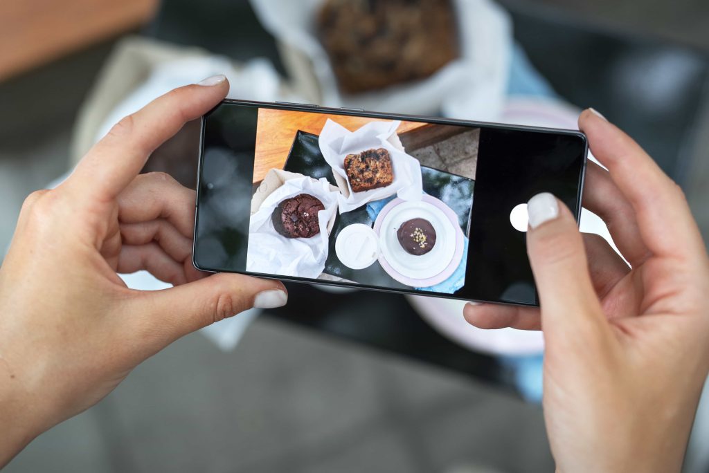 Person taking photo of pastries